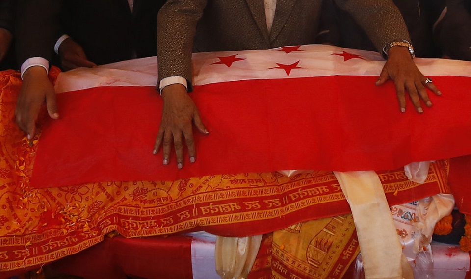 Senior leaders of Nepali Congress party lay the party flag on the body of late former Prime Minister Sushil Koirala in Kathmandu