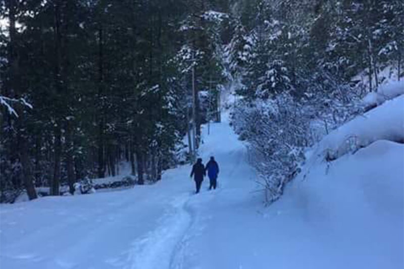 People seen walking along the snow-covered road in Manang. Photo: Ramji Rana