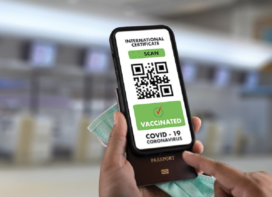 man travel Immigration Passport Map to showof a certificate of vaccination against the Covid-19 at airport