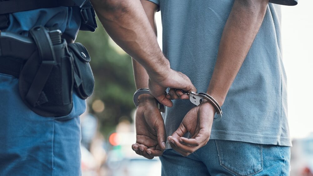 Handcuffs,,Police,And,Hands,Of,Police,Man,With,Criminal,In